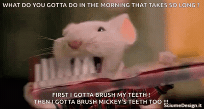 A White Mouse Is Brushing Its Teeth With A Toothbrush GIF