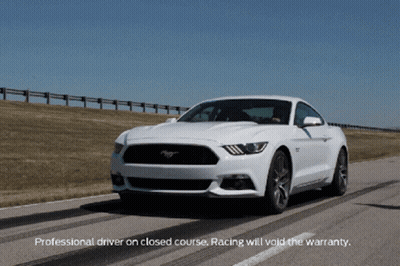 A White Mustang Is Driving Down A Road With The Words Professional Driver On Closed Course Racing Will Void The Warranty GIF