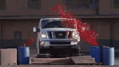 A White Nissan Van Is Jumping Over A Pallet GIF