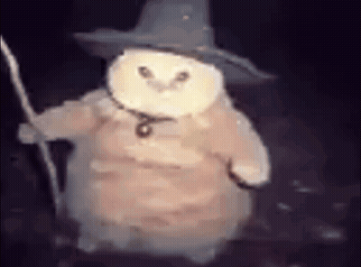 A White Owl Wearing A Wizard Hat And Holding A Wand . GIF