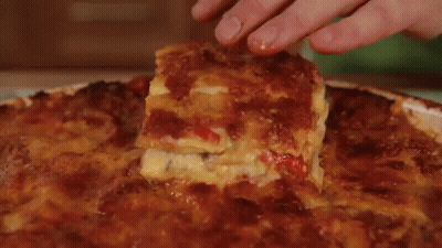 A White Plate Topped With A Slice Of Lasagna . GIF