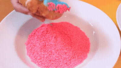 A White Plate Topped With Pink Sprinkles And A Piece Of Bread . GIF
