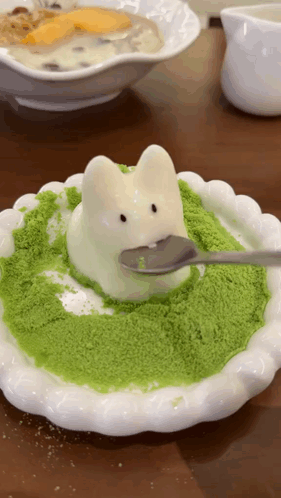 A White Plate With A Bunny On It And A Spoon On Top Of It GIF
