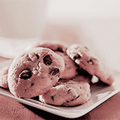 A White Plate With Chocolate Chip Cookies On It GIF