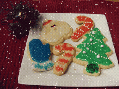 A White Plate With Christmas Cookies On It GIF