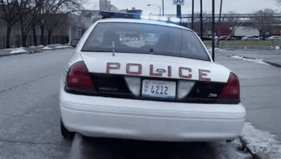 A White Police Car With A License Plate That Says 4412 GIF