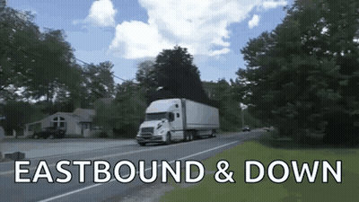 A White Semi Truck Is Driving Down A Road With The Words Eastbound & Down Written Below It GIF