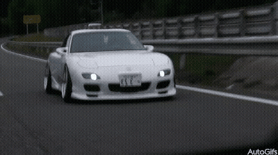 A White Sports Car Is Driving Down A Road With A License Plate That Says Esc GIF