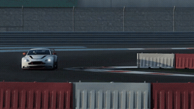 A White Sports Car Is Driving On A Race Track With Other Cars GIF