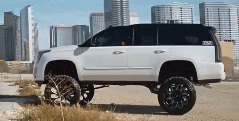 A White Suv With Black Wheels And A Sticker That Says ' Texas ' On It GIF