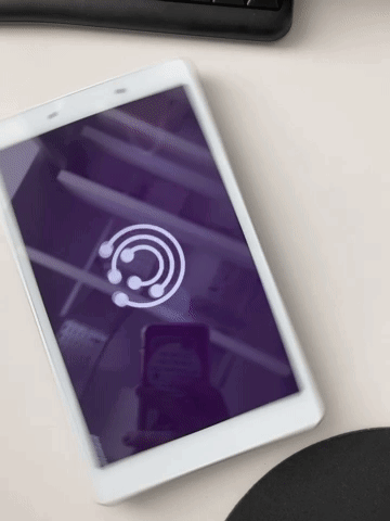 A White Tablet With A Purple Screen And A White Circle On The Screen GIF
