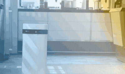 A White Trash Can In A Kitchen With The Letter G On The Top GIF