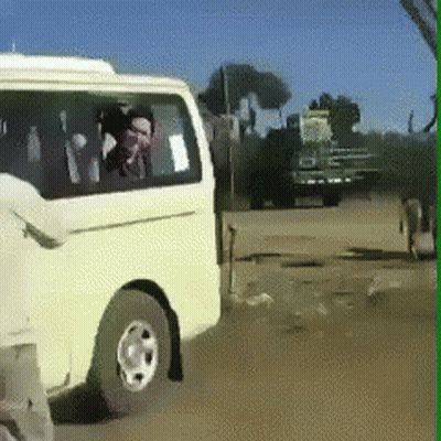 A White Van Is Parked On The Side Of A Road GIF
