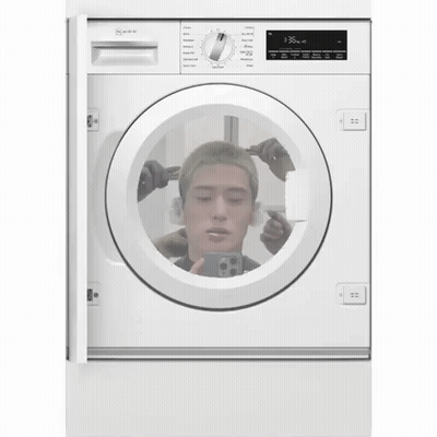 A White Washing Machine Has A Picture Of A Man 'S Head In It GIF