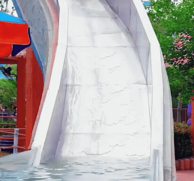 A White Water Slide Is Going Down A Slope GIF
