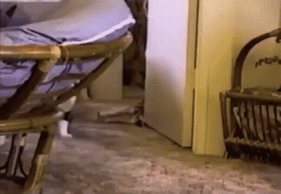 a wicker chair is sitting in a room next to a door