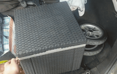A Wicker Ottoman Sits In The Back Of A Car GIF