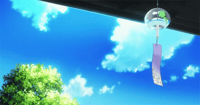 A Wind Chime With A Green Frog On It Hangs From A Roof GIF