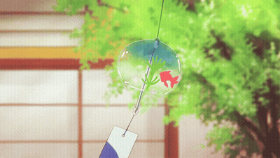 A Wind Chime With A Red Fish In It Is Hanging From A String GIF