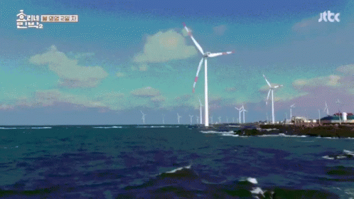A Windmill In The Middle Of A Body Of Water With Jttc Written On The Bottom Right GIF