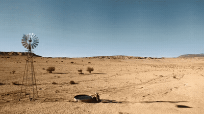 A Windmill In The Middle Of A Dry Desert GIF