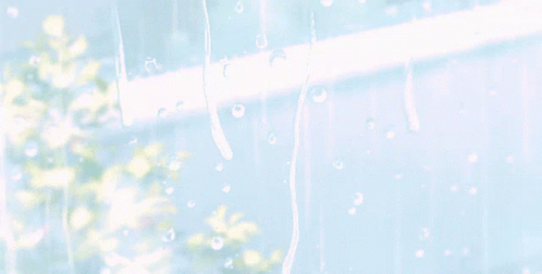 A Window With Rain Drops On It And The Sun Shining Through GIF