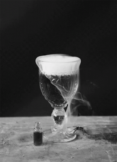 A Wine Glass With Smoke Coming Out Of It GIF