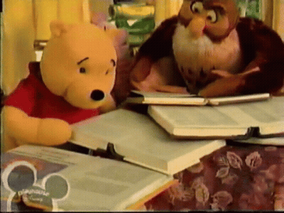 A Winnie The Pooh And An Owl Sit At A Table With Books GIF