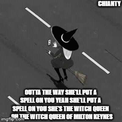 A Witch Is Sitting On A Broom In The Middle Of A Street . GIF