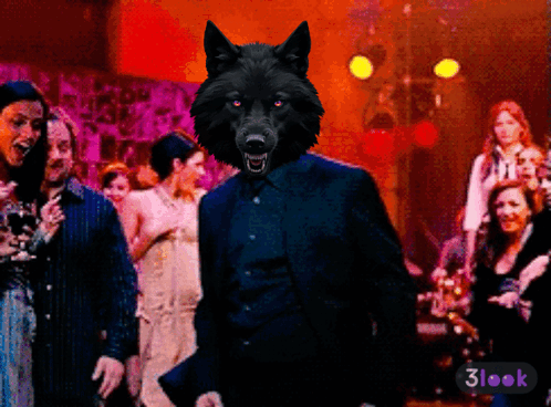A Wolf In A Suit Stands In Front Of A Crowd Of People With A 3Look Sticker On The Bottom Right GIF
