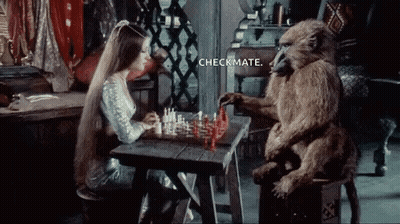 A Woman And A Baboon Are Playing Chess At A Table . GIF