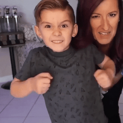 A Woman And A Child Are Posing For A Picture GIF