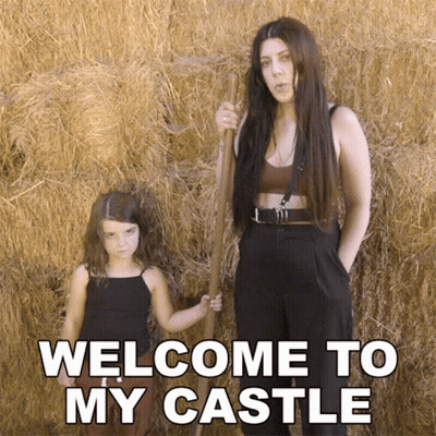A Woman And A Little Girl Are Standing In Front Of Hay Bales With The Words Welcome To My Castle Written On The Bottom GIF