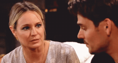 A Woman And A Man Are Looking At Each Other GIF