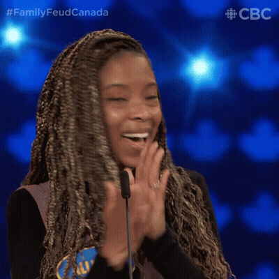 A Woman Applauds In Front Of A Microphone With The Words Family Feud Canada On The Bottom Right GIF