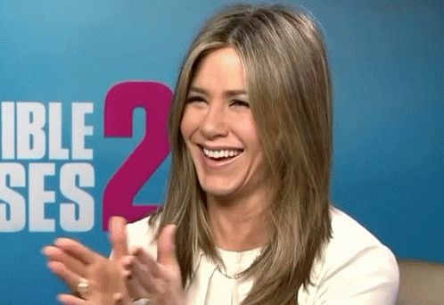 A Woman Applauds In Front Of A Sign That Says Ible Ses 2 GIF
