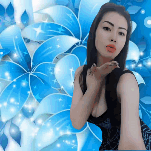A Woman Blowing A Kiss In Front Of A Blue Background GIF