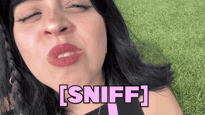 A Woman Blowing A Kiss With The Word Sniff Written In Pink GIF