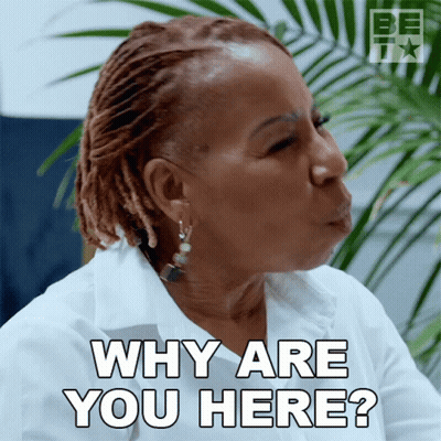 A Woman Blowing A Kiss With The Words " Why Are You Here " Behind Her GIF