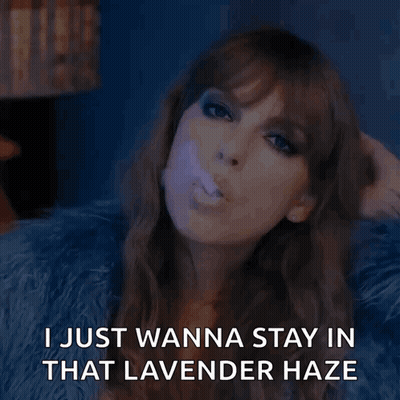 A Woman Blowing A Purple Bubble With The Words " I Just Wanna Stay In That Lavender Haze " Below Her GIF