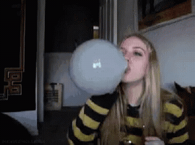 A Woman Blowing Up A Bubble With A Macbook Logo On It GIF