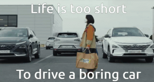 A Woman Carrying A Bag With The Words Life Is Too Short To Drive A Boring Car On It GIF