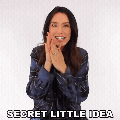 A Woman Clapping Her Hands With The Words Secret Little Idea Written Below Her GIF