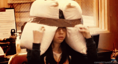 A Woman Covering Her Ears With A Pillow And The Url Conniekt.tumblr.com GIF