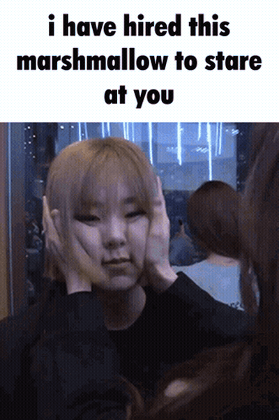 A Woman Covering Her Ears With Her Hands And A Caption That Says I Have Hired This Marshmallow To Stare At You GIF