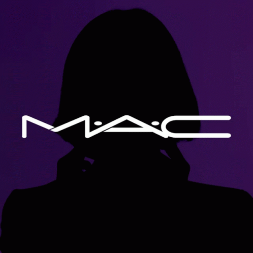 A Woman Covering Her Face With A Mac Logo Behind Her GIF