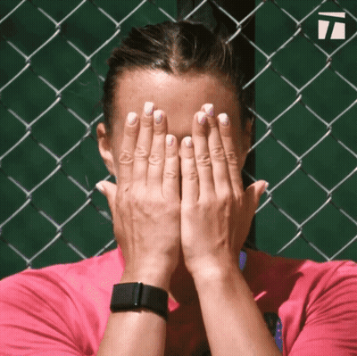 A Woman Covering Her Face With Her Hands While Wearing A Smart Watch GIF