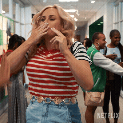 A Woman Covering Her Mouth In A Hallway With Netflix Written On The Bottom GIF