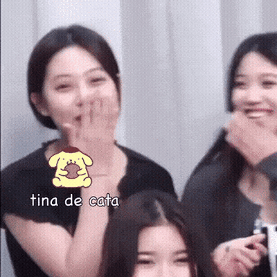 A Woman Covering Her Mouth With Her Hand And The Word Tina De Cata Is On The Bottom GIF