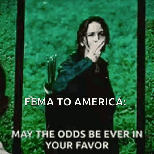 A Woman Covering Her Mouth With Her Hand And The Words Fema To America May The Odds Be Ever In Your Favor Below Her GIF